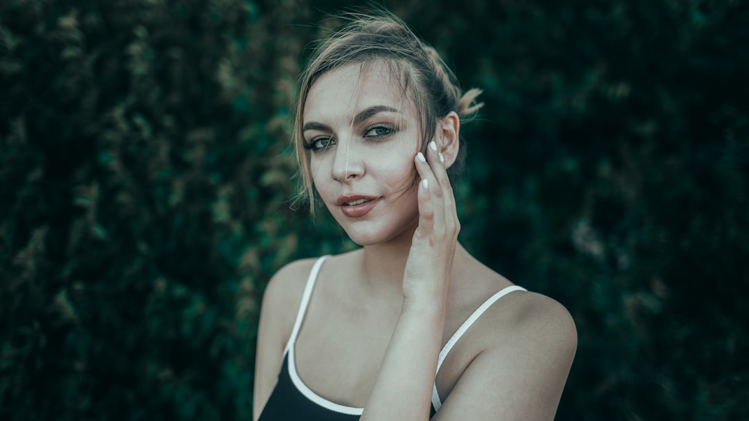 Young woman with hand on cheek experiencing tooth sensitivity